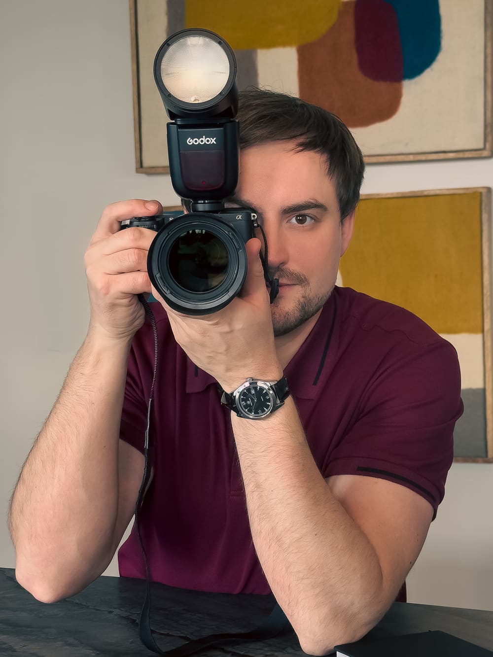 Viktor Kovalov at his desk with camera and laptop