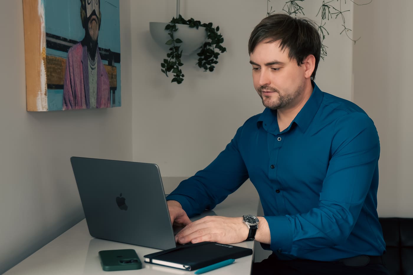 Viktor Kovalov working at a laptop in his studio